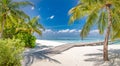 wooden pier pathway into paradise island in Maldives. Tropical shore, palm trees white sand, tranquility Royalty Free Stock Photo