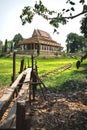 Wooden pier into pond with sunken boat at temple Wat Krabi Riel Pagoda vertical, Siem Reap Province, Cambodia Royalty Free Stock Photo