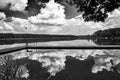 Wooden pier and reflection of clouds in the waters of Lake Chycina Royalty Free Stock Photo