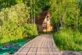 A wooden pier running from the lake to the fisherman`s house on Royalty Free Stock Photo