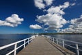 Wooden pier in the sea against a blue sky Royalty Free Stock Photo