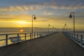 Wooden pier by the sea lit by stylish lamps at night Royalty Free Stock Photo