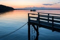 Wooden pier at the shore of the Baltic Sea during a beautiful colorful sunset Royalty Free Stock Photo