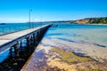 Wooden pier stretches out into clear bue water Royalty Free Stock Photo