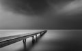 Wooden pier stretching out into the fog