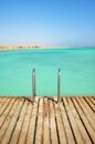 Wooden pier with swim ladder, tropical summer vacation concept