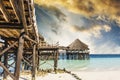 Wooden pier with thatched roof in ocean