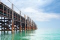 Wooden pier on turquoise water, blue sky, clouds background, ship wharf scenic perspective view seascape, fishing boat dock, quay Royalty Free Stock Photo