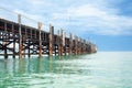 Wooden pier on turquoise water, blue sky, clouds background, ship wharf scenic perspective view seascape, fishing boat dock, quay Royalty Free Stock Photo