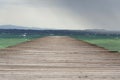 Wooden pier with waves on Lago di Garda Sirmione, Italy Royalty Free Stock Photo