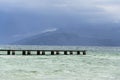 Wooden pier with waves on Lago di Garda Sirmione, Italy Royalty Free Stock Photo