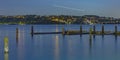 Wooden pillars in Tacoma with contrail in the sky Royalty Free Stock Photo