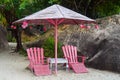 Wooden pink umbrella and chairs on tropical beach in Khanh Hoa, Vietnam Royalty Free Stock Photo