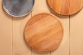 Wooden pizza boards and gray ceramic plate top view