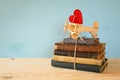 Wooden plane with heart on the stack of old books Royalty Free Stock Photo