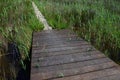 Wooden plank bridge leads to tiled passage across marshy land near healing muds and beaches of Nin, croatia, adriatic