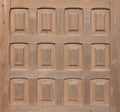 Wooden plank with 12 carved rectangles. middle plan of an antique european style door