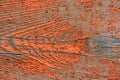 Wooden plank with cracked red paint