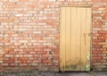 Wooden plank door, brick wall