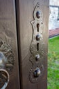 Wooden door, metallic escutcheon, brown painted