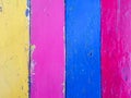 Wooden plank painted with colorful yellow, pink,blue and red color in stripes pattern Royalty Free Stock Photo