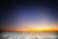 Wooden plank and starry night background in the sunrise time