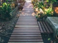 Wooden plank walkway between green garden in the house Royalty Free Stock Photo