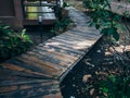 Wooden plank walkway between green garden in the house Royalty Free Stock Photo