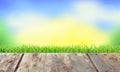Wooden planks floor in the green grass and blue sky Royalty Free Stock Photo