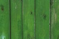 Wooden planks of green color on the fence as an abstract background