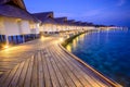 Wooden planks in the Maldives island to a bungalow on the water