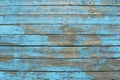 Wooden planks with peeling blue paint