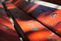 Wooden planks of a red bench in the sidewalk alongside Lana river, Tirana, Albania Royalty Free Stock Photo