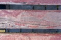 Wooden planks of red color from the bench close up Royalty Free Stock Photo