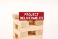 On the wooden planks there is a red one with the inscription - Project deliverables