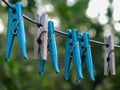 Wooden and plastic clothespins hanging from a wire Royalty Free Stock Photo