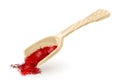 Wooden or plastic scoop with dry saffron. Red spice, condiment using in cooking.
