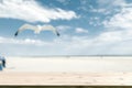 Wooden plate and blurred outdoor photo. Sunny day on sandy beach, seagull and sky Royalty Free Stock Photo