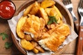 Wooden plate with British traditional fish and potato chips Royalty Free Stock Photo