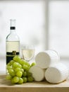 Wooden plate of cheese grapes and wine Royalty Free Stock Photo