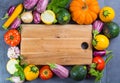 Wooden plate with copy space, restautant concept with fresh organic vegetables - round courgette, small eggplants, tomatoes, diet Royalty Free Stock Photo