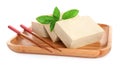 Wooden plate with raw tofu, basil and chopsticks on white background Royalty Free Stock Photo