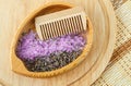 Wooden plate with dry lavender  purple bath salts (foot soak) and wooden hair brush. Royalty Free Stock Photo