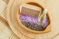 Wooden plate with dry lavender  purple bath salts (foot soak)  wooden hair brush and bottle with esential oil. Royalty Free Stock Photo