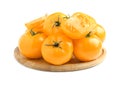 Wooden plate of fresh ripe yellow tomatoes isolated on white Royalty Free Stock Photo