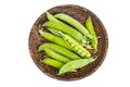 Wooden plate with green pea pods on white Royalty Free Stock Photo