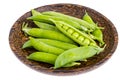 Wooden plate with green pea pods on white Royalty Free Stock Photo