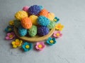 Wooden plate piled high the decorative Easter eggs and felt flowers