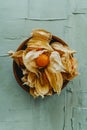 Wooden plate with some ripe groundcherries