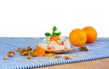 A Wooden Plate Of Turkish Delight Or Lokum, Walnuts, Dried Apricots And Sappy Oranges On A White Background.